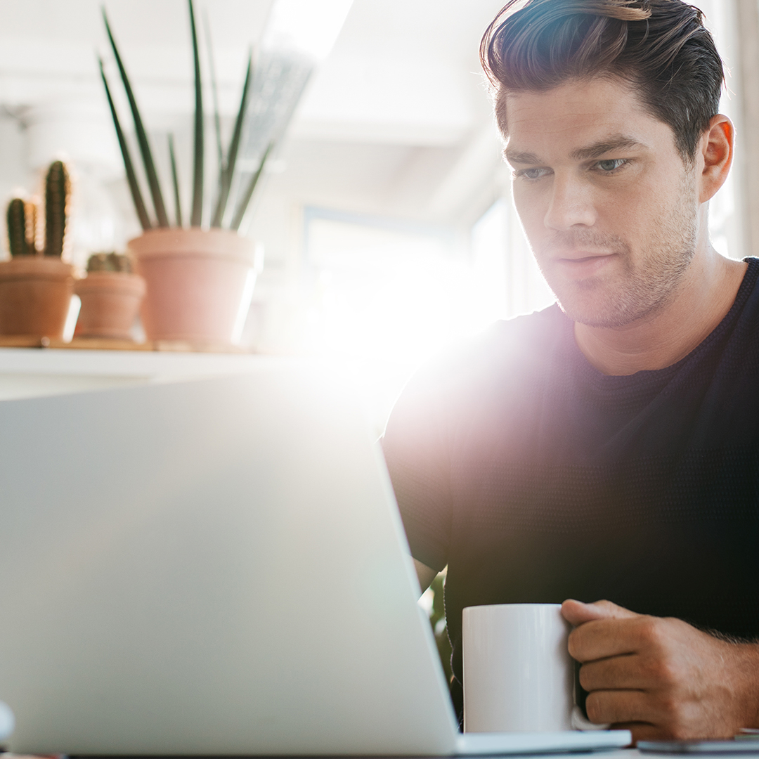 Image of a man on his computer