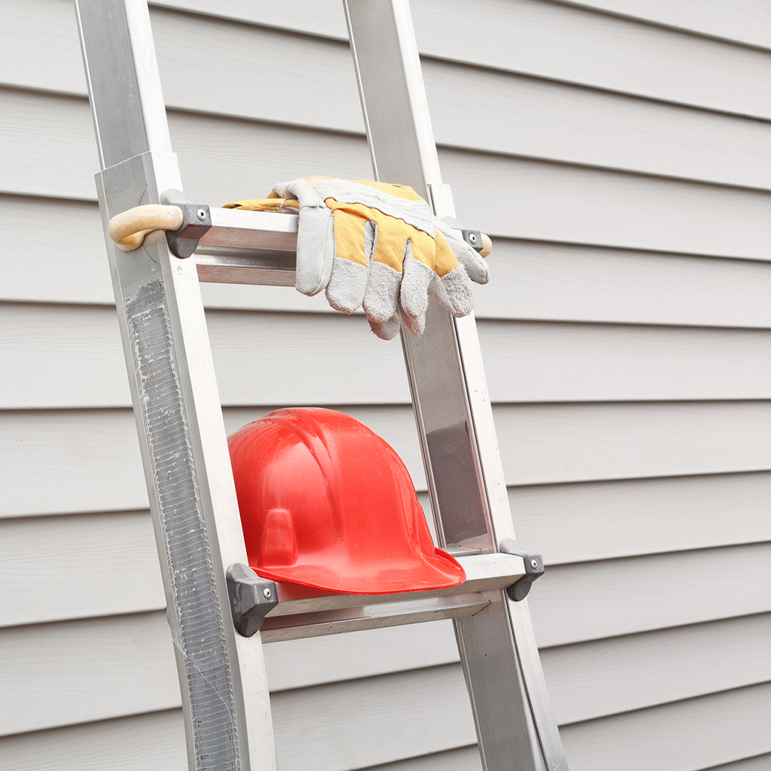Image of a ladder leaning against a house