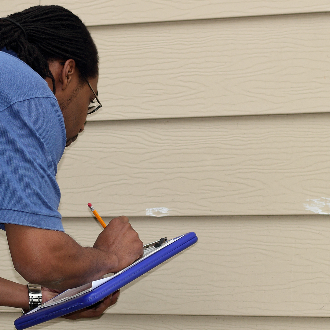 Image of an inspector looking at damage