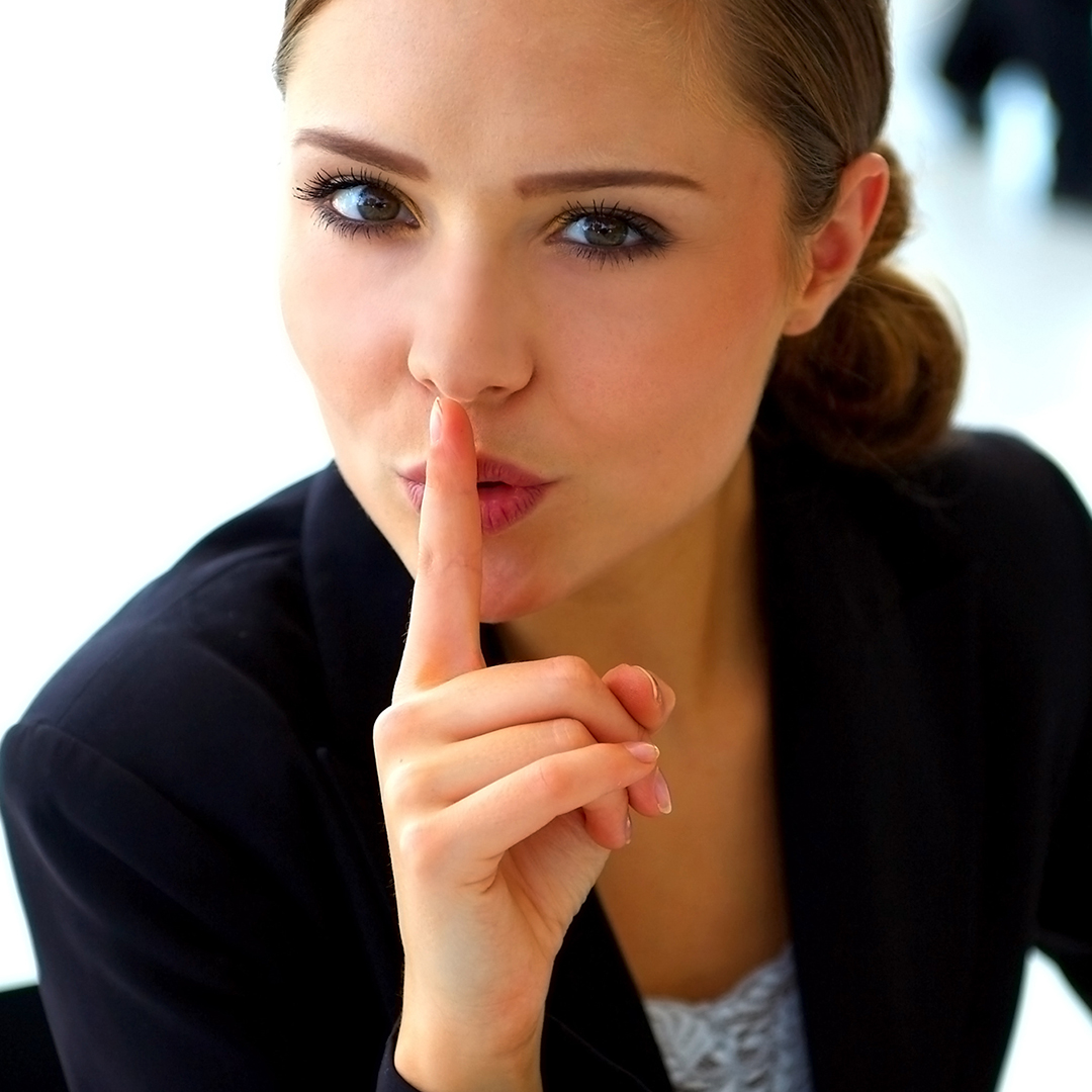 Image of a woman pressing her finger to her lips