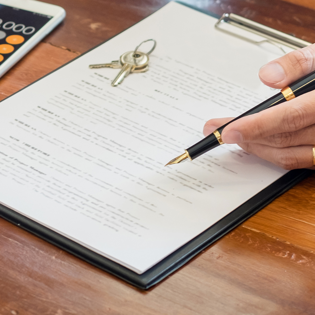 Image of a person with a contract and a pen