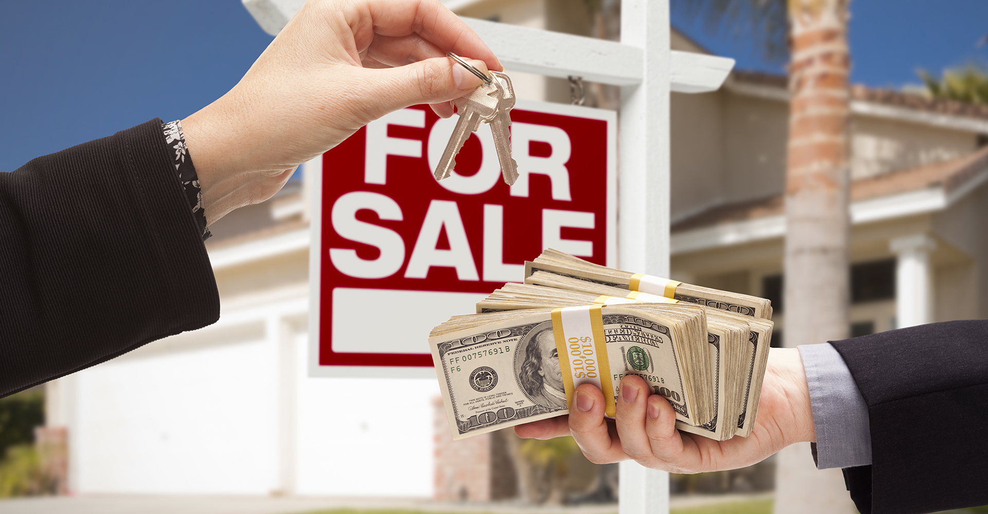 Image of two people exchange house keys and cash